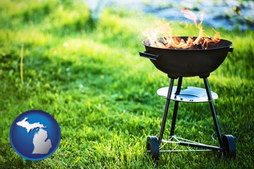 a round barbecue grill - with Michigan icon