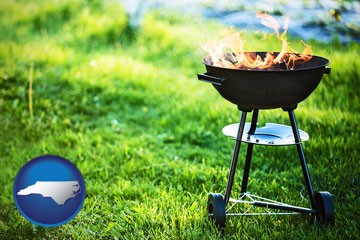 a round barbecue grill - with North Carolina icon