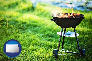 a round barbecue grill - with North Dakota icon
