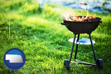 a round barbecue grill - with Nebraska icon