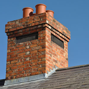 a red brick chimney with four flues