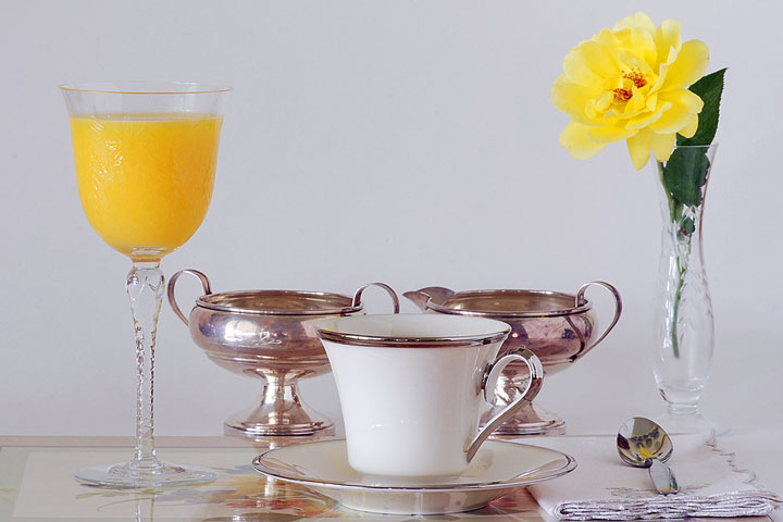 a china teacup, crystal vase, and silver cream and sugar set (large image)