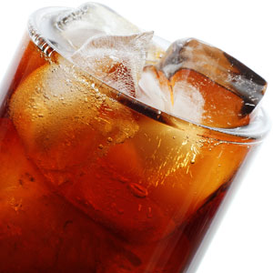 a glass of cola with ice cubes