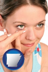 arkansas map icon and a young woman inserting a contact lens