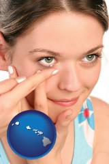 hawaii map icon and a young woman inserting a contact lens