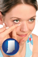 indiana map icon and a young woman inserting a contact lens