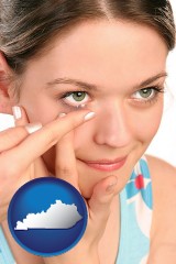kentucky map icon and a young woman inserting a contact lens