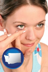 washington map icon and a young woman inserting a contact lens