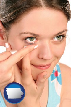 a young woman inserting a contact lens - with Iowa icon