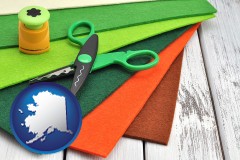 alaska map icon and craft supplies (colorful felt and a pair of scissors)