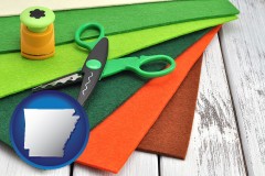 arkansas map icon and craft supplies (colorful felt and a pair of scissors)