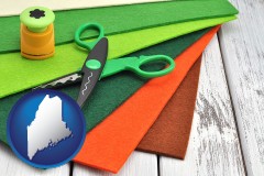 maine map icon and craft supplies (colorful felt and a pair of scissors)