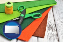 south-dakota map icon and craft supplies (colorful felt and a pair of scissors)