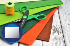 wy map icon and craft supplies (colorful felt and a pair of scissors)
