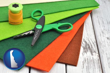 craft supplies (colorful felt and a pair of scissors) - with Delaware icon