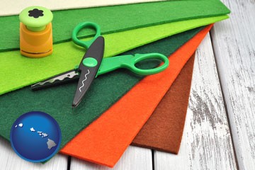 craft supplies (colorful felt and a pair of scissors) - with Hawaii icon