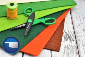 craft supplies (colorful felt and a pair of scissors) - with Oklahoma icon