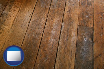 a distressed wood floor - with Colorado icon