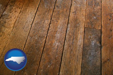 a distressed wood floor - with North Carolina icon