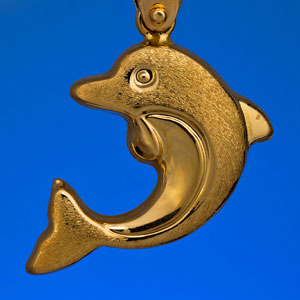 a gold dolphin pendant