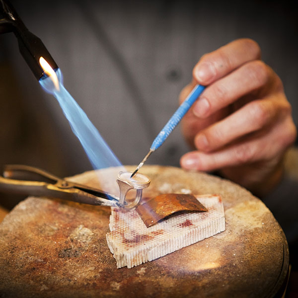 a goldsmith making a custom gold ring (large image)