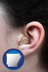 arkansas map icon and a woman wearing a hearing aid in her left ear