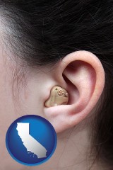 california map icon and a woman wearing a hearing aid in her left ear