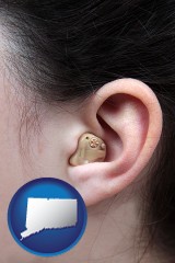 connecticut map icon and a woman wearing a hearing aid in her left ear