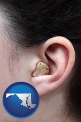 maryland map icon and a woman wearing a hearing aid in her left ear