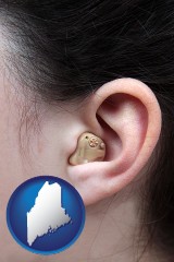 maine map icon and a woman wearing a hearing aid in her left ear