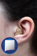 new-mexico map icon and a woman wearing a hearing aid in her left ear