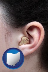 ohio map icon and a woman wearing a hearing aid in her left ear
