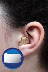 pennsylvania map icon and a woman wearing a hearing aid in her left ear