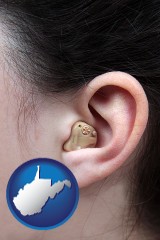 west-virginia map icon and a woman wearing a hearing aid in her left ear