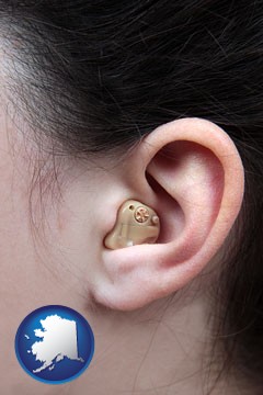 a woman wearing a hearing aid in her left ear - with Alaska icon