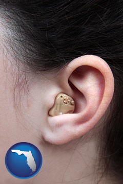 a woman wearing a hearing aid in her left ear - with Florida icon