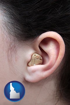 a woman wearing a hearing aid in her left ear - with Idaho icon