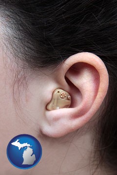 a woman wearing a hearing aid in her left ear - with Michigan icon