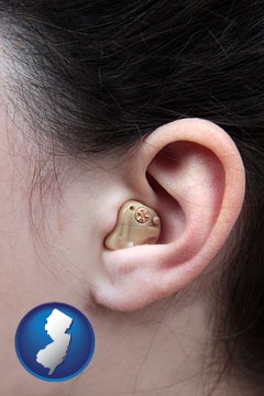 a woman wearing a hearing aid in her left ear - with New Jersey icon