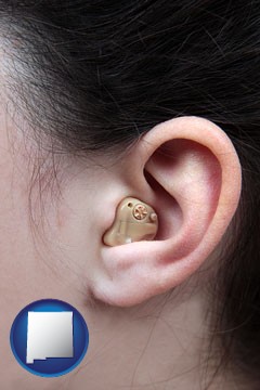 a woman wearing a hearing aid in her left ear - with New Mexico icon