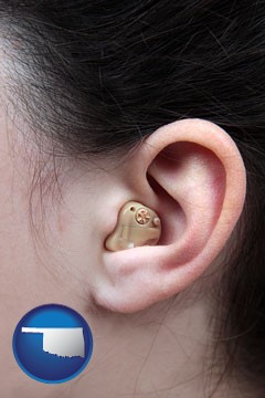 a woman wearing a hearing aid in her left ear - with Oklahoma icon