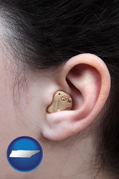 a woman wearing a hearing aid in her left ear - with Tennessee icon