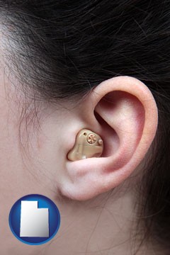 a woman wearing a hearing aid in her left ear - with Utah icon