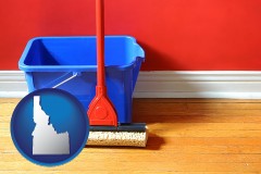 idaho map icon and a bucket and mop on a hardwood floor