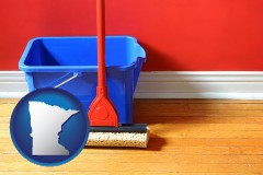 minnesota map icon and a bucket and mop on a hardwood floor