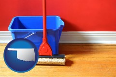 oklahoma map icon and a bucket and mop on a hardwood floor