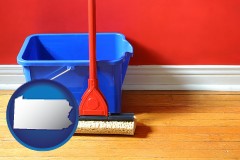 pennsylvania map icon and a bucket and mop on a hardwood floor
