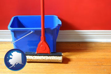 a bucket and mop on a hardwood floor - with Alaska icon