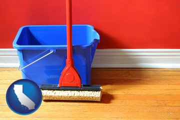 a bucket and mop on a hardwood floor - with California icon