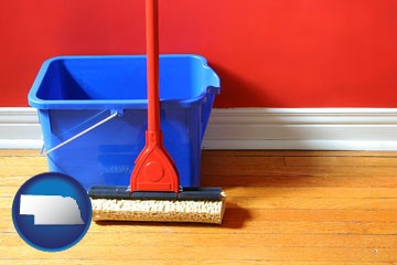 a bucket and mop on a hardwood floor - with Nebraska icon
